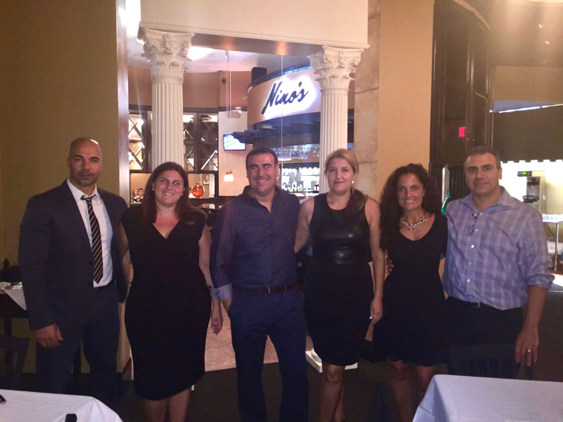 A group posing together at Nino's bar